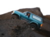 1996 Ford Bronco - 1996 Ford Bronco navigating challenging terrain on a dirt hill.