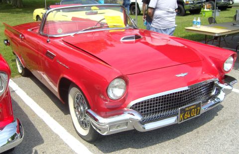 2007 Ford Mustang - A red 1957 Ford Thunderbird convertible is parked at an outdoor event.