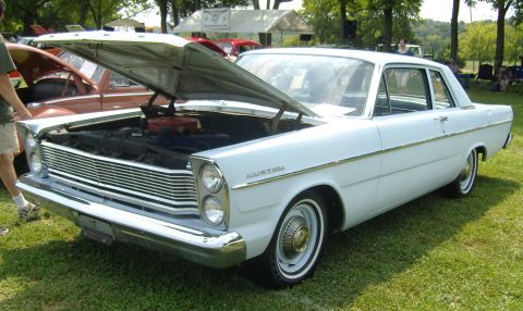2007 Ford Mustang - A white 1965 Ford Galaxie 500 is displayed with its hood open at an outdoor car show.