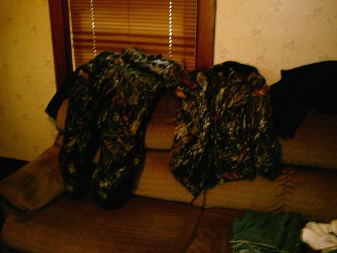2001 Dodge 2500 - Two camouflage jackets are placed on a couch in front of a window with blinds. The image also shows a watermark for Supermotors.net.