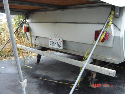 1993 Ford Bronco - Pop-up tent trailer rear view with California license plate.