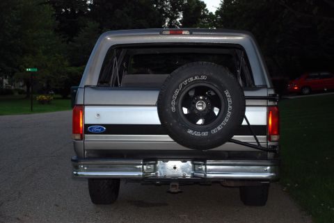 1995 Ford Bronco - Rear view of a 1995 Ford Bronco, showing its spare tire and distinctive body style.