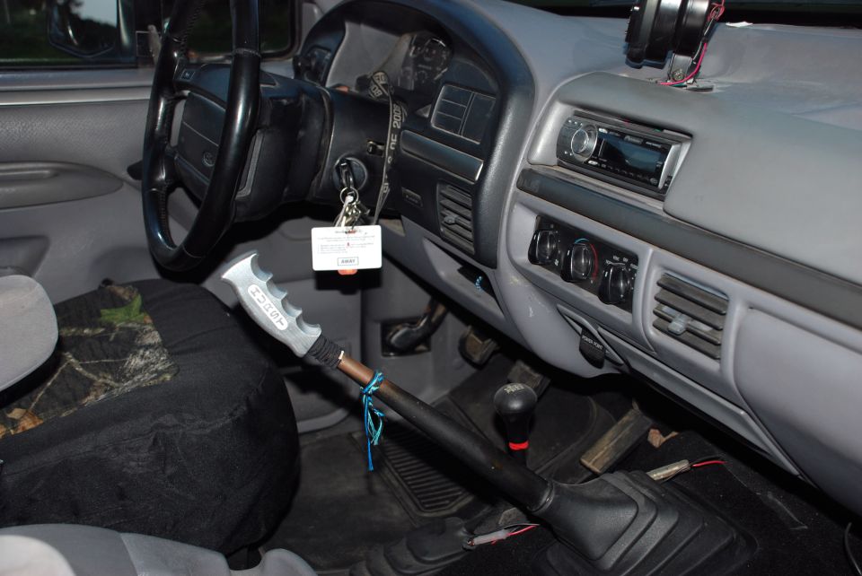 Interior shot of a truck cab, showing the steering wheel, dashboard, radio, and gear shifter
