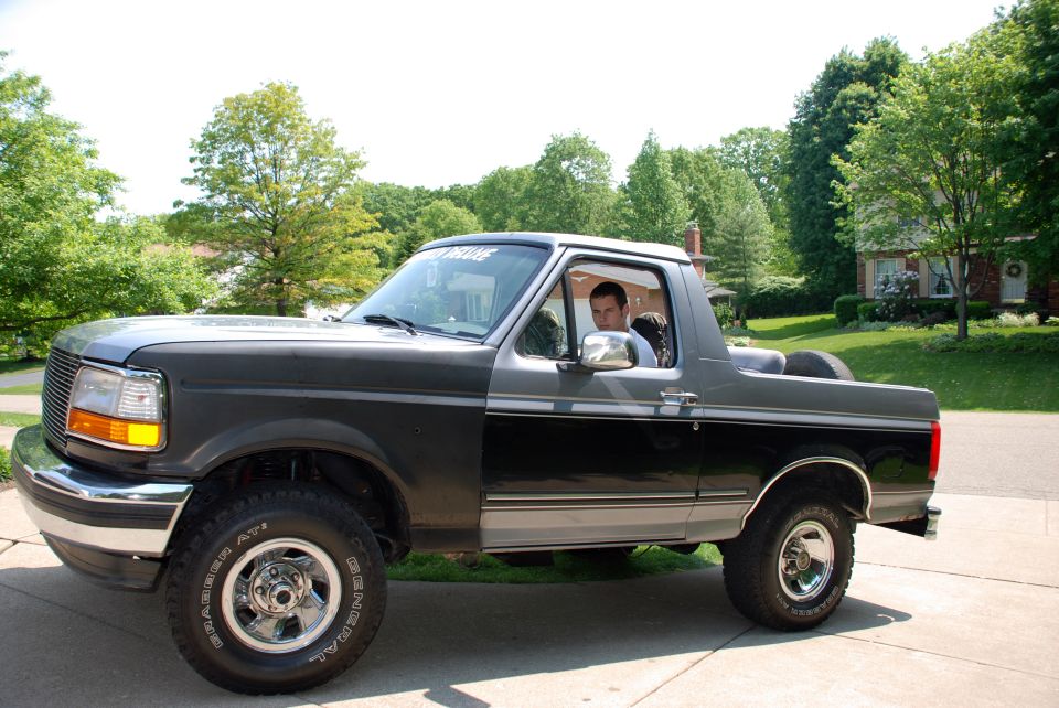 Two-tone gray and black 1995 Ford Bronco parked in driveway