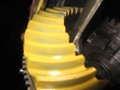 1995 Ford Bronco - Differential ring gear with yellow coating and visible teeth.