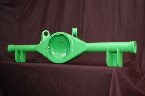 1992 Ford Mustang - A bright green rear axle housing is displayed against a dark fabric background.
