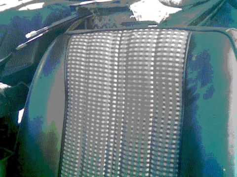 1978 Ford Mustang II - Car seat upholstery features a distinct checkered pattern with dark green vinyl sides. Supermotors logo is present.