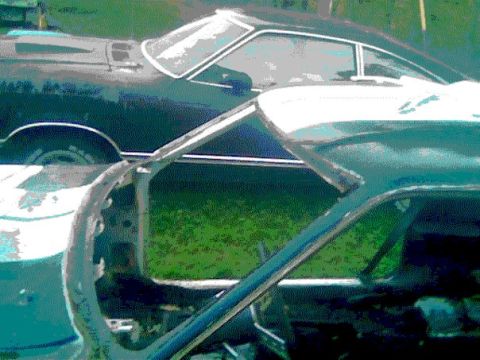1978 Ford Mustang II - Two cars are parked side-by-side in a grassy area, with one in the foreground and another behind it.