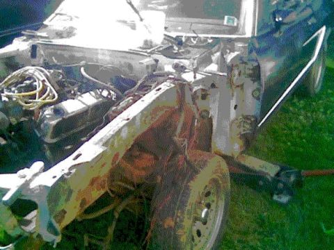 1978 Ford Mustang II - The engine bay of a 1978 Ford Mustang II shows significant rust and disrepair, with the engine and front chassis exposed.