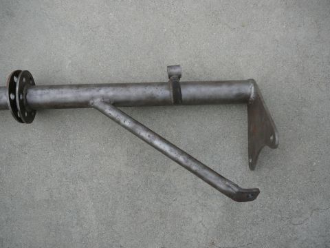 1988 Ford Bronco - A metal suspension component is shown against a concrete background.