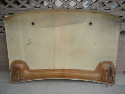 1988 Ford Bronco - The underside of a car hood is shown, revealing its construction and mounting hardware.