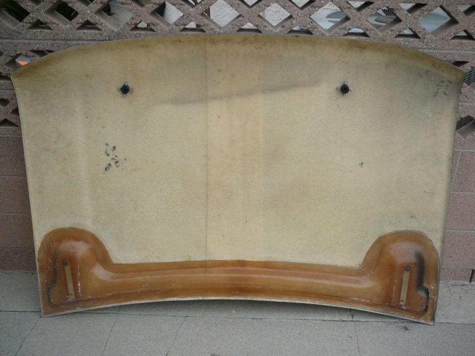 underside of a car hood, showing mounting points and fiberglass construction