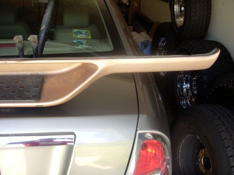 1993 Ford Bronco - A tan plastic trim piece with a textured black insert is visible, likely from a car's rear bumper.