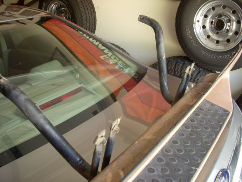1993 Ford Bronco - Metal tubing structure attached near the rear window of a vehicle, with tires in the background.