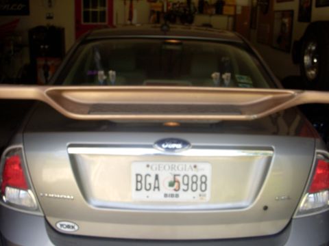 1993 Ford Bronco - The rear of a sedan is shown, a spoiler and a Georgia license plate.