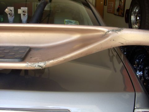 1993 Ford Bronco - A close-up of a damaged side step, showing wear and tear on a vehicle.