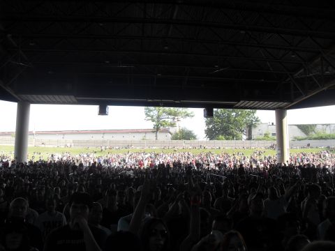 1988 Ford Bronco - A large crowd gathers for an outdoor concert, viewed from under a covered seating area.