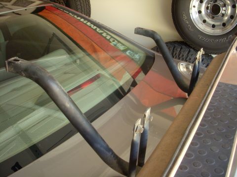 1993 Ford Bronco - Two metal bars are placed on the rear window of a vehicle, possibly for a roll cage.