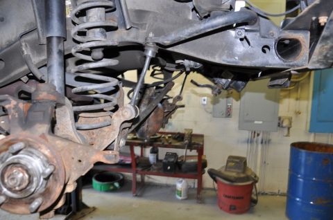 1996 Ford Bronco - Close-up view of vehicle suspension components, suggesting repair or maintenance work in a workshop.