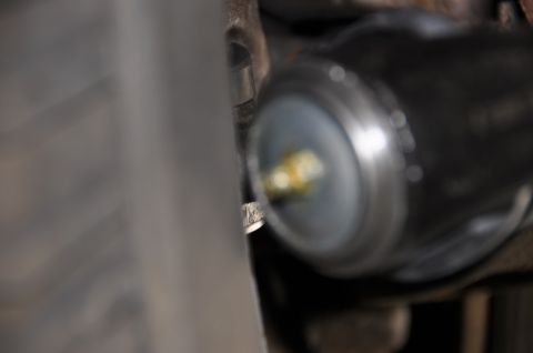 1996 Ford Bronco - Detail of a lubricated metal component, focus on texture and grease.