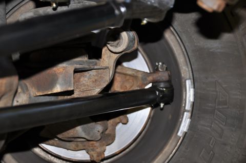 1996 Ford Bronco - Underside view of a vehicle's steering and suspension components, including the wheel and tire.