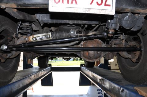1996 Ford Bronco - Vehicle undercarriage with lift kit components visible, including a Superlift shock absorber.
