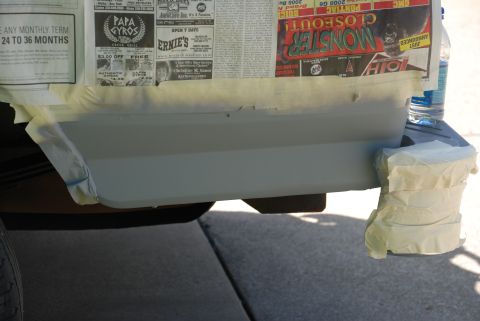 1995 Ford Bronco - The rear bumper and lower body panel are taped off and appear to be undergoing preparation for a paint job.