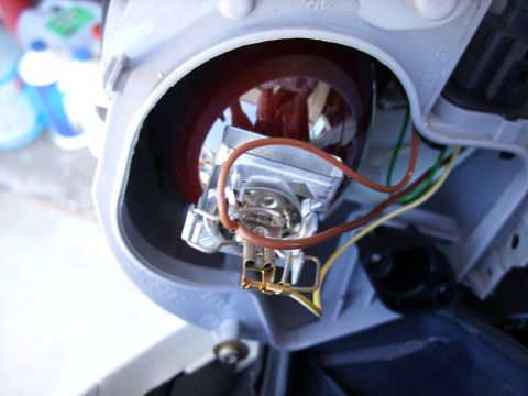 2003 Volkswagen Beetle - Close-up view of a vehicle's headlight assembly, showing the bulb and electrical connections.