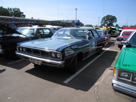 1991 Ford LTD Crown Victoria - blue full-size Plymouth State Police sedan with a single roof light, parked among other classic police cars at a show.