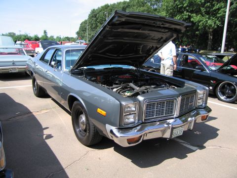 1991 Ford LTD Crown Victoria - gray full-size Plymouth sedan with its hood raised exposing the engine bay, parked at a car show.