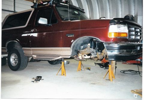 1996 Ford Bronco - This 1996 Ford Bronco is undergoing front-end work, with its wheels off and supported by jack stands.