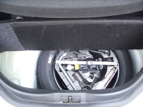 2003 Volkswagen Beetle - The trunk compartment holds a spare tire and a tool kit for tire changes.