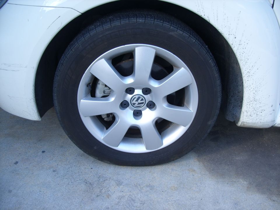 Old tires with plenty of tread but also plenty of cracks from age.