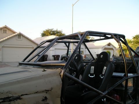 1986 Toyota Hilux - This custom-built buggy features a full roll cage and racing seats, suggesting it's modified for off-road use.