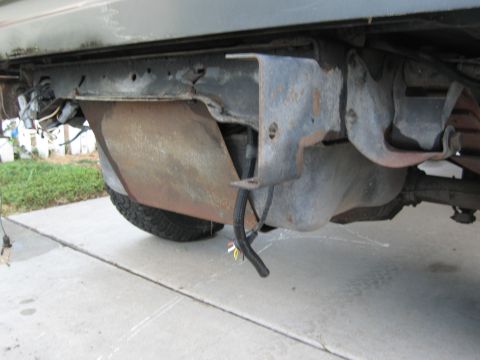 1986 Ford Bronco - This photo shows the undercarriage of a vehicle, focusing on the gas tank and surrounding frame components.