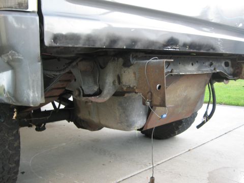 1986 Ford Bronco - Underside view of a 1986 Ford Bronco, focusing on the gas tank and surrounding frame components.
