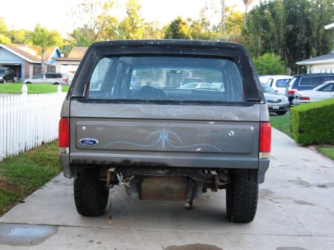 1986 Ford Bronco - This 1986 Ford Bronco is viewed from the rear, showing its gray body and black hardtop.
