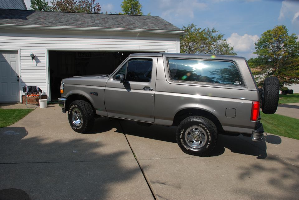 Gray 1995 Ford Bronco parked in driveway next to garage
