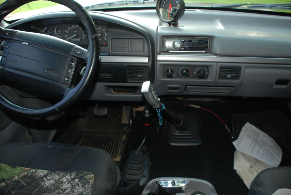 Interior of a 1995 Ford Bronco showing dashboard and tachometer