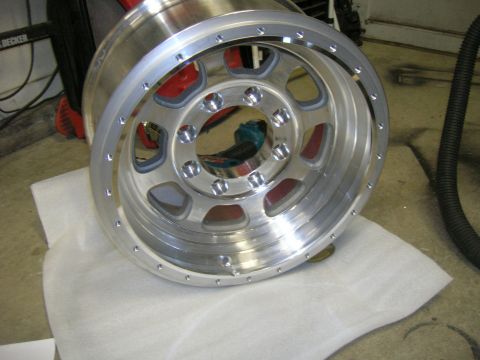 1996 Ford Bronco - A close-up view of a single aluminum wheel, likely for a truck or SUV, resting on a protective surface.