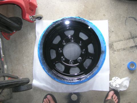 1996 Ford Bronco - Wheel being prepped for painting, with masking tape applied to the rim.