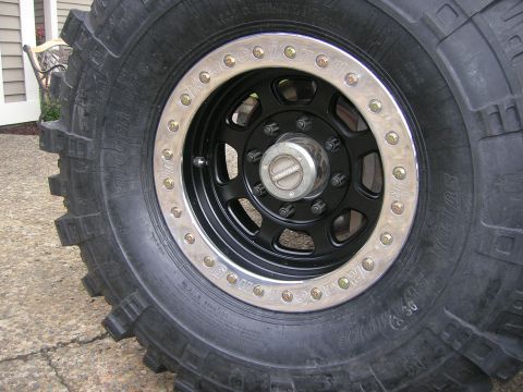 1996 Ford Bronco - Close-up of a modified off-road wheel and tire assembly, showing custom detailing and a prominent brand name.