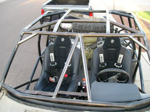 1986 Toyota Hilux - A custom-built off-road vehicle interior is shown, racing seats and a protective roll cage.