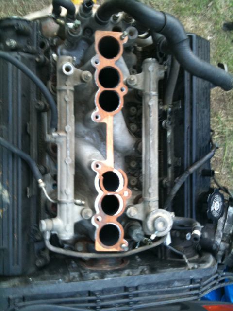 1993 Toyota 4Runner - Close-up view of an engine's intake manifold, showing the gasket surface and ports.