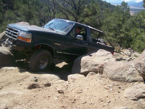 1993 Ford Bronco - This 1993 Ford Bronco tackles a challenging off-road course with large rocks and steep inclines.