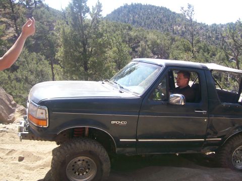 1993 Ford Bronco - Driver navigates a 1993 Ford Bronco on a rocky, off-road trail.