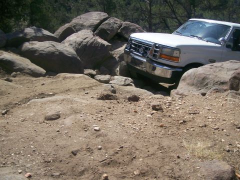 1993 Ford Bronco - This Ford F-Series truck navigates a challenging rocky path, demonstrating its off-road capability.