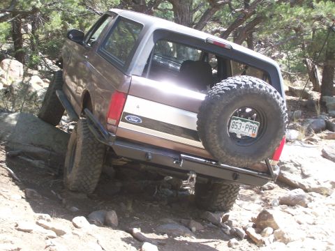 1993 Ford Bronco - This Ford Bronco is navigating a challenging rocky terrain, its off-road capabilities.
