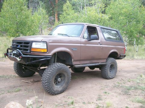 1993 Ford Bronco - This modified Ford Bronco is equipped with large off-road tires and a winch for terrain.