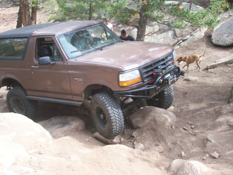 1993 Ford Bronco - This modified 1993 Ford Bronco navigates a challenging rocky terrain on an off-road trail.